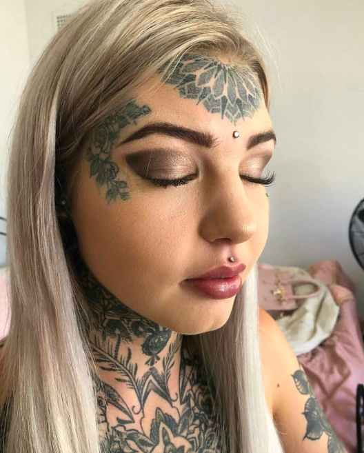woman with tattoo and split tongue
